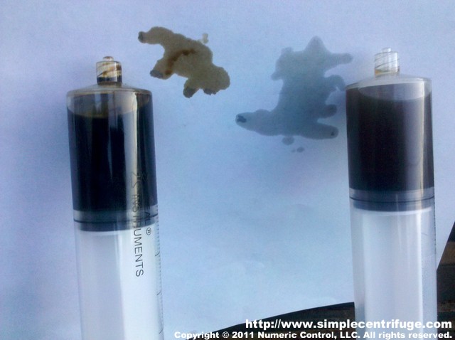 The oil samples side by side. The distilled oil on the right is much cleaner looking oil on the paper.